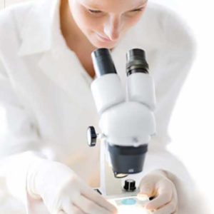 Woman looking in to microscope